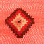 détail housse coussin laine petite croix sur fond bois de rose tissée main